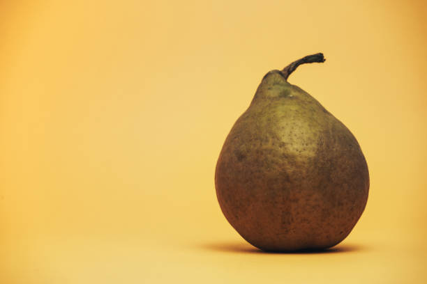 istock Beautiful on pear on a yellow background. 1180209334