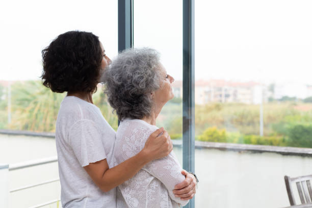 istock Peaceful middle aged and senior women watching scene from window 1180210188