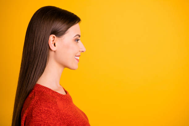 istock Photo of beautiful cute charming nice girlfriend looking into empty space created for new information isolated over yellow vivid color background 1180210821