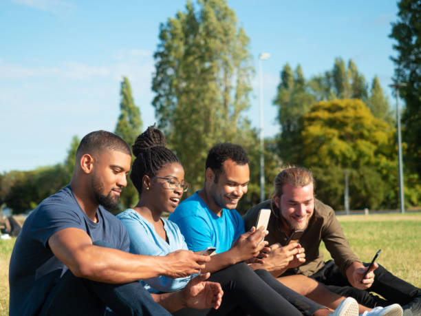 istock Multiethnic friends sharing content on phones 1180210876