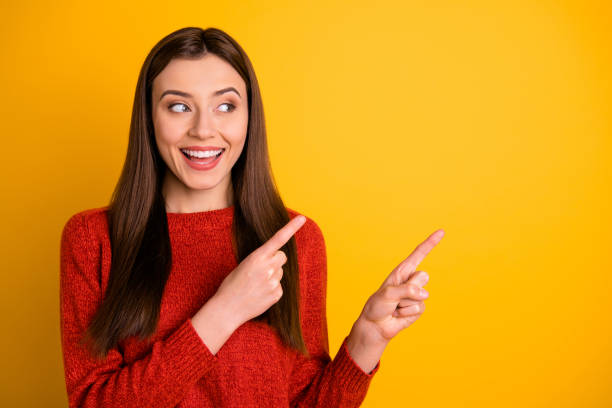 istock Photo of white cheerful cute nice charming gorgeous millennial pointing at empty space expressing pleasure with face isolated over vivid color background 1180211000