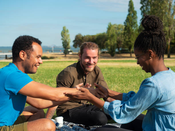 istock Joyful multiethnic having fun on park lawn 1180213196