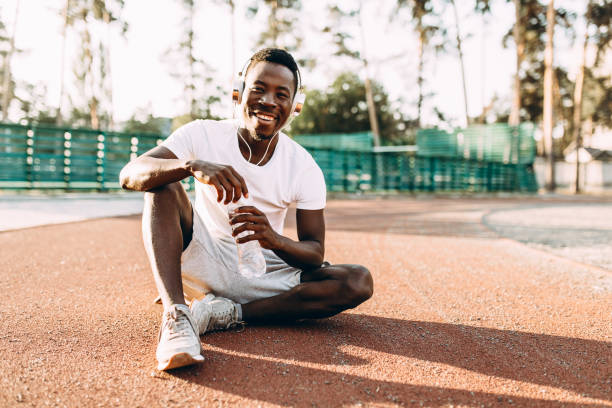 istock Young athletic African American relaxes after intense workout 1180214141