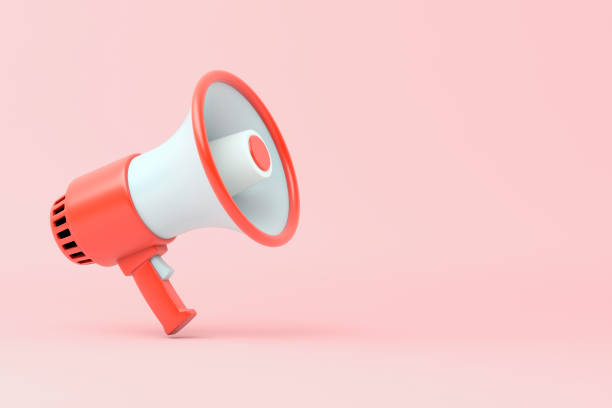 istock Single red and white electric megaphone with a handle stands on a pink background 1180214258