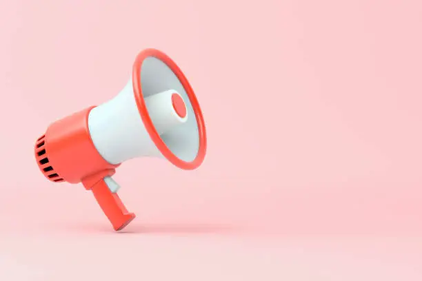 Photo of Single red and white electric megaphone with a handle stands on a pink background