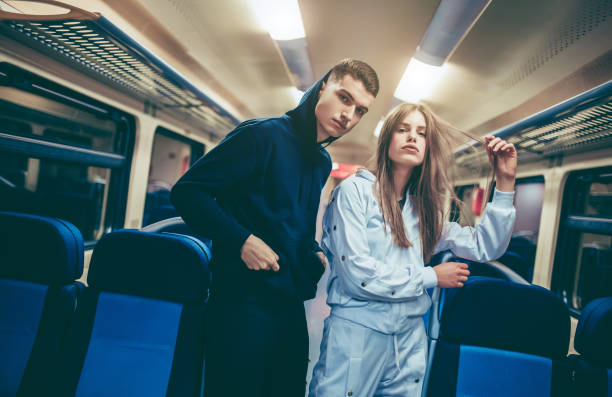 pareja joven en un vehículo de tren - pants fotografías e imágenes de stock