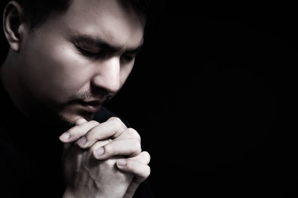 istock praying asian man. human emotion facial expression feeling 1180217113