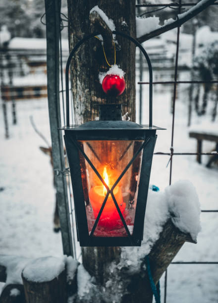 istock Candle lantern lights burning in snow 1180217265