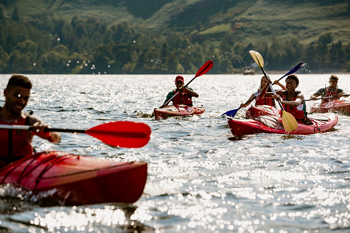 A group of friends having fun kayaking on Derwent Water in The Lake District