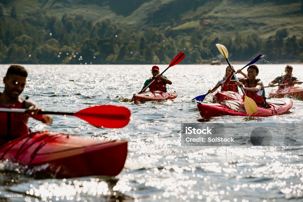 Group of Friends Kayaking A group of friends having fun kayaking on Derwent Water in The Lake District Kayaking Stock Photo