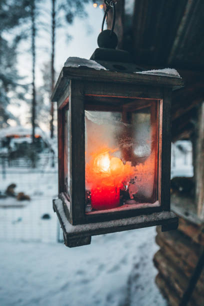 istock Candle lantern lights burning in snow 1180217377