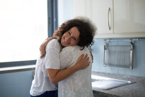 istock Middle aged woman hugging senior mother 1180217455