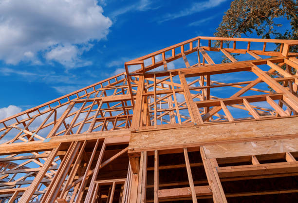 Home new stick built home under construction a blue sky Home new wood frame stick built home under construction a blue sky pallet industrial equipment photos stock pictures, royalty-free photos & images