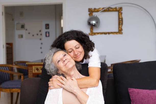 istock Happy peaceful middle aged woman hugging elderly lady 1180219190