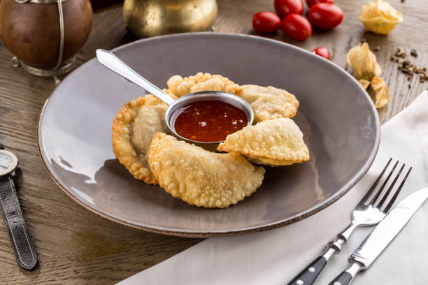 istock Fried dumplings with tomato sauce on plate on wooden table 1180221263
