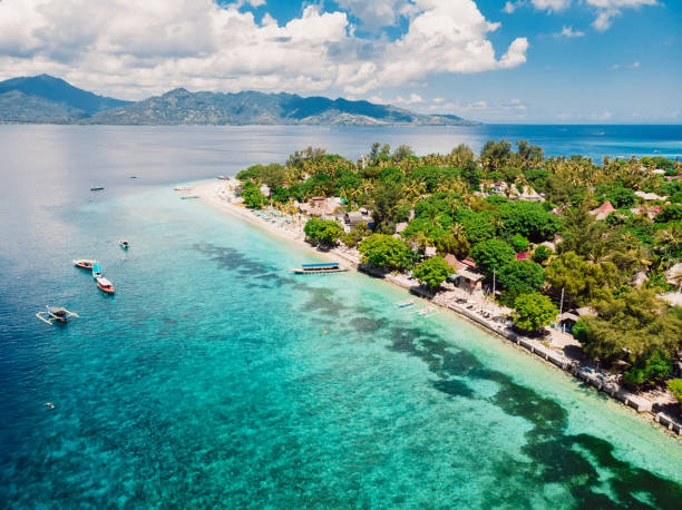 Tropical island with beach and turquoise transparent ocean, aerial view. Gili islands Tropical island with beach and turquoise transparent ocean, aerial view. Gili islands lombok indonesia stock pictures, royalty-free photos & images
