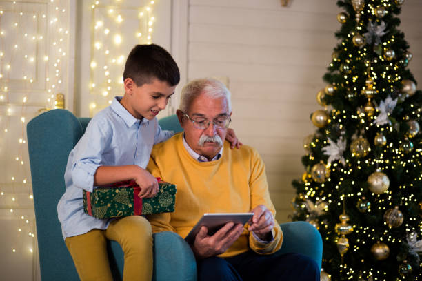 istock Grandpa and his grandson using tablet for the Christmas eve 1180222015