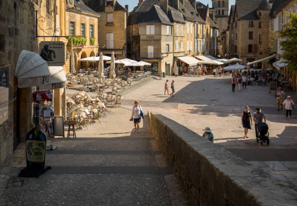 Historic houses surrounding Place de la Liberte in Sarlat la Caneda in Dordogne Department, Aquitaine, France Sarlat, France - September 2, 2018: Historic houses surrounding Place de la Liberte in  Sarlat la Caneda in Dordogne Department, Aquitaine, France sarlat la caneda stock pictures, royalty-free photos & images