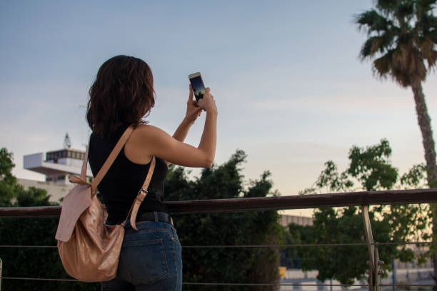istock Young woman is taking a picture with her mobile 1180224785