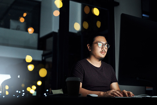 Cropped shot of a male computer programmer working late in the office on a new code