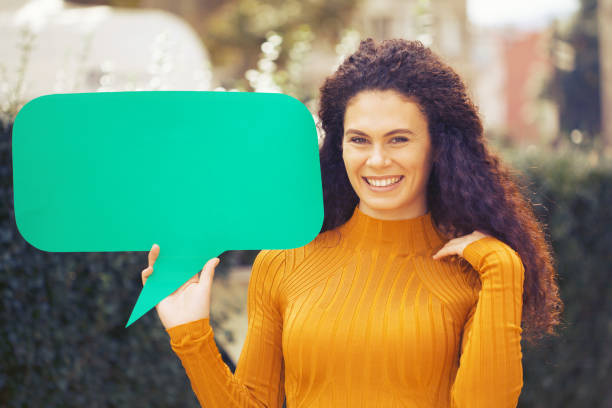 istock Young woman holding a chat bubble 1180226432