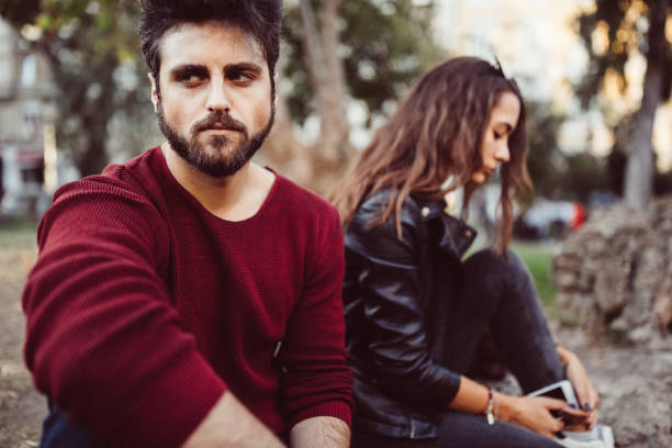 istock Young couple with problems in the city park 1180226530