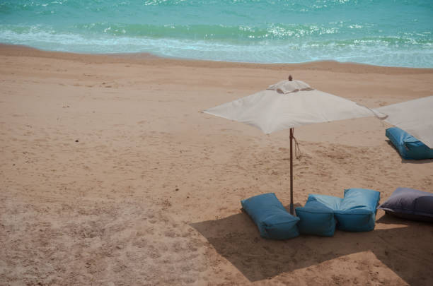 istock Mattresses and umbrellas on the beach. 1180226743