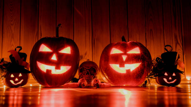 istock Halloween pumpkin head jack lantern over red wooden shining background 1180227638