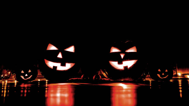istock Halloween concept. Pumpkin head jack lantern lighting in darkness 1180227675