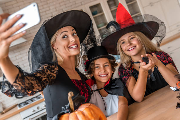 istock Happy young family taking selfie in Halloween decorated kitchen 1180227751