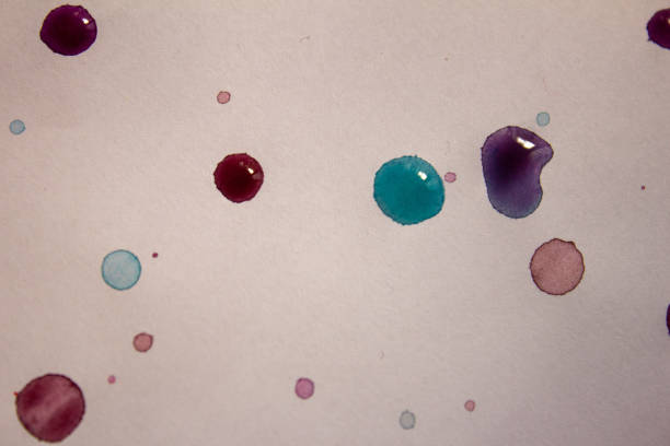 istock Water colour drops over white background. Abstract background of colour drops. 1180228122