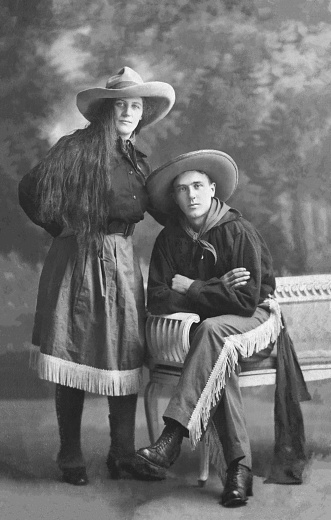 Vintage 1915´s portrait of a handsome young couple dressed up as cowgirl and cowboy adn getting ready for a masquerade ball party in Amsterdam, the Netherlands.