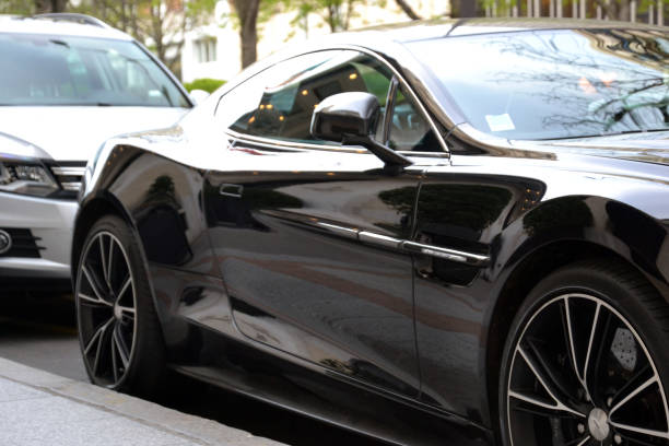 Paris, France - April 17th 2016 : focus on the sheet metal of a black Aston Martin Vanquish parked in George V Avenue (back side).