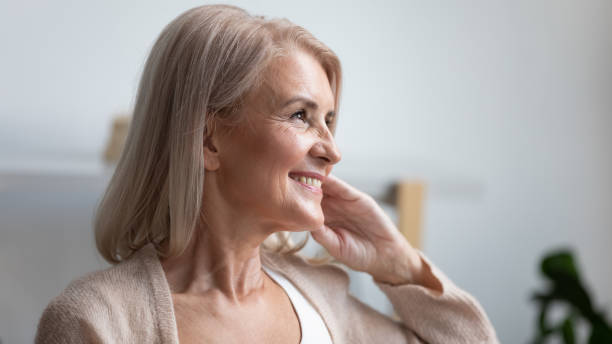 istock Close up profile smiling mature woman dreaming about good future 1180231094