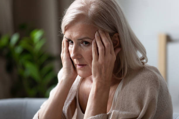 istock Upset older woman touching temples, feeling bad, mental disorder 1180231102