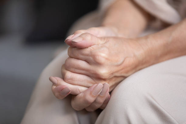 istock Close up unhappy lonely mature woman folded hands together 1180231103