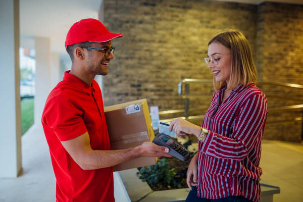 istock Woman client paying for her order upon delivery 1180231186
