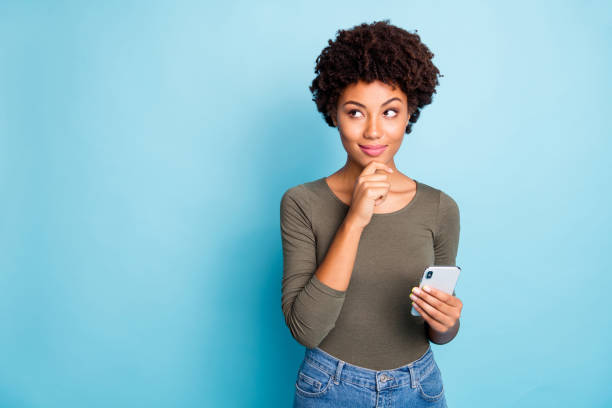 Photo of cunning smirking puzzled interested dark skinned youngster touching her chin in thought of what to post to her profile on social media wearing jeans denim isolated over vivid color blue background Photo of cunning smirking puzzled interested dark skinned youngster, touching her chin in thought of what to post to her profile on social media wearing jeans denim isolated over vivid color blue background smirking stock pictures, royalty-free photos & images