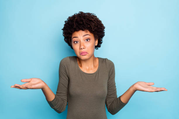 I dont care. Portrait of doubtful negative curly hair afro american girl cant choose answer solve trouble shrug shoulders hold hands hesitate wear beautiful outfit isolated blue color background I dont care. Portrait of doubtful negative curly hair afro american girl cant choose, answer solve trouble shrug shoulders hold hands hesitate wear beautiful outfit isolated blue color background indifference stock pictures, royalty-free photos & images