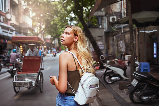 Shot of an attractive young woman using her cellphone while out exploring the wonderful city of Hanoi in Vietnam