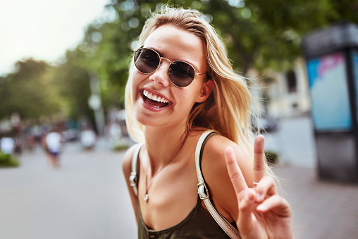 Portrait of an attractive young woman wearing sunglasses enjoying herself while exploring the wonderful city of Hanoi in Vietnam