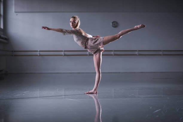 istock Beautiful jazz ballerina having training in studio. 1180234291