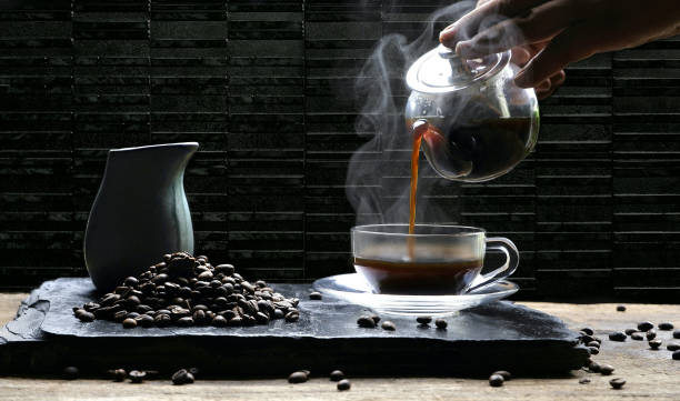 istock Pouring hot coffee into glass coffee cup 1180235345