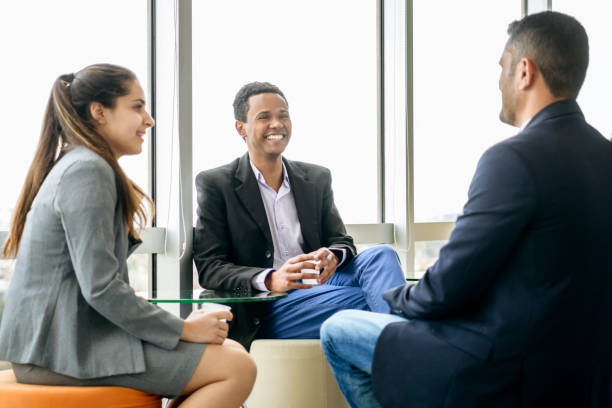 istock Three business people chatting and smiling 1180235432