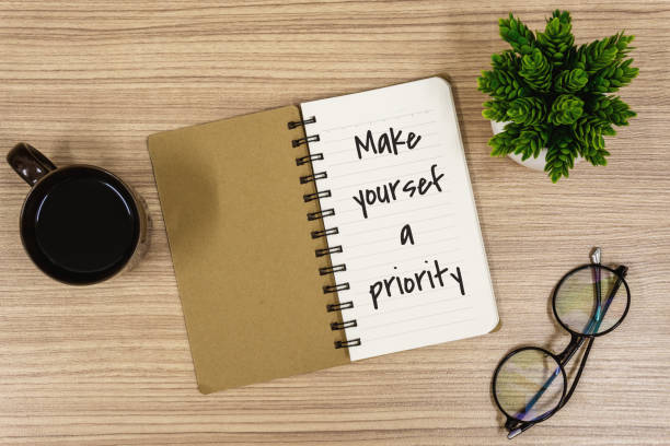 istock Notebook with Inspirational Quote on Wooden Work Desk 1180236021
