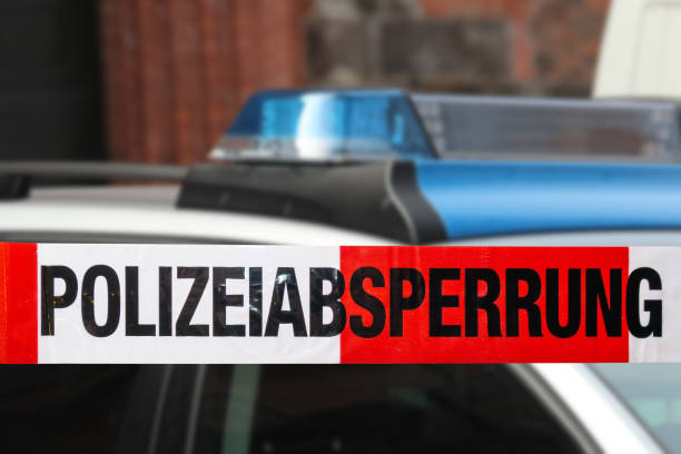 istock German police car with cordon tape 1180240112