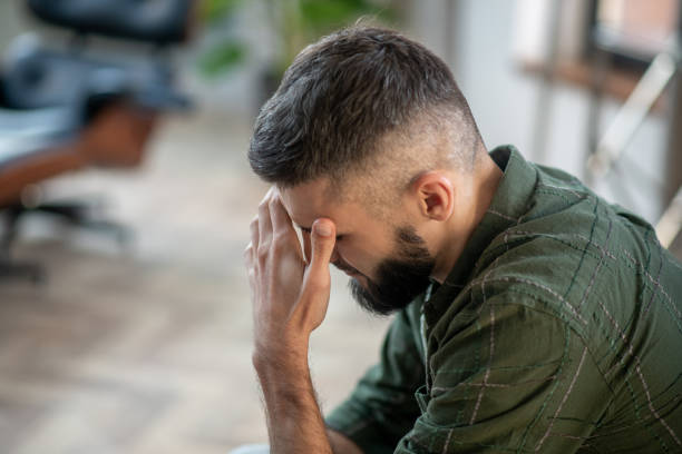 istock Bearded man wearing checked shirt having strong headache 1180241469