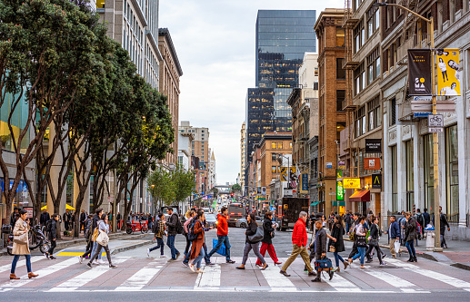 San Francisco, USA - People crossing a busy road in downtown San Francisco.