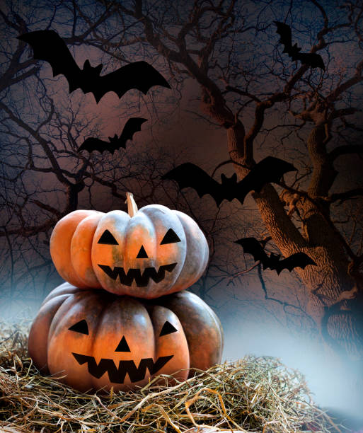 istock Pumpkins on hey on dark background with bats. Halloween concept 1180244423