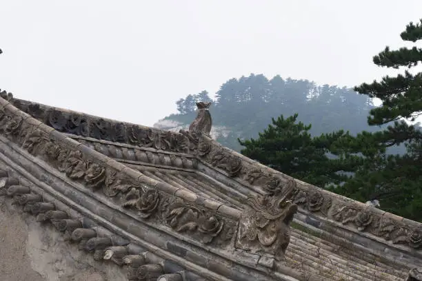 Photo of Beautiful Chinese ancient traditional roof with stone carving in Sacred Taoist mountain Mount Huashan, popular touristic place in China